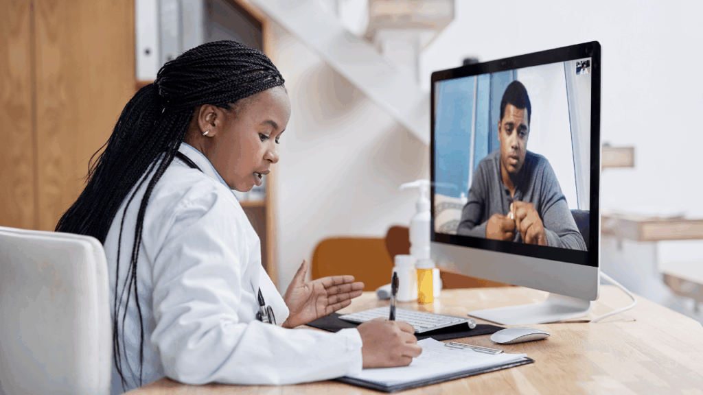 A female doctor in a white coat conducts a telehealth consultation